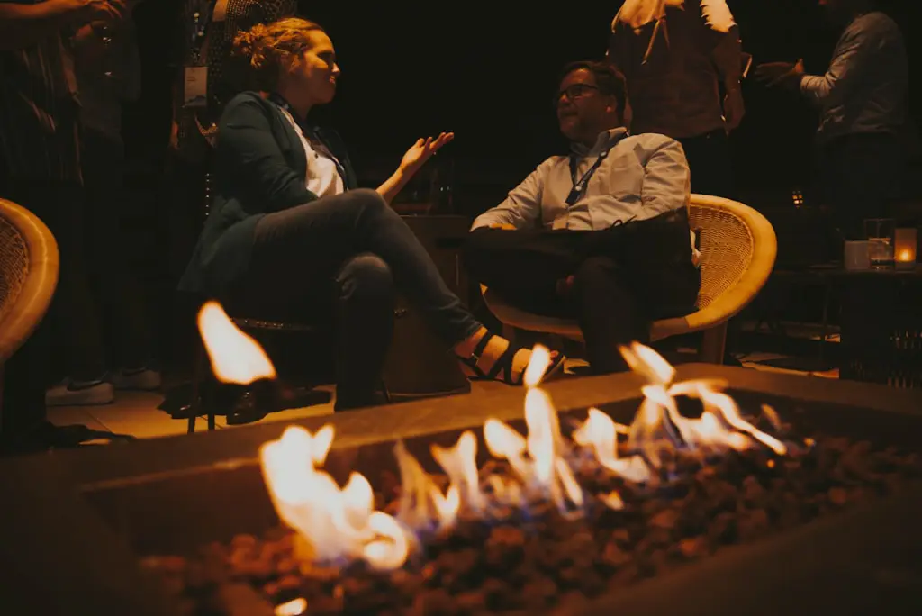 people sitting around a campfire