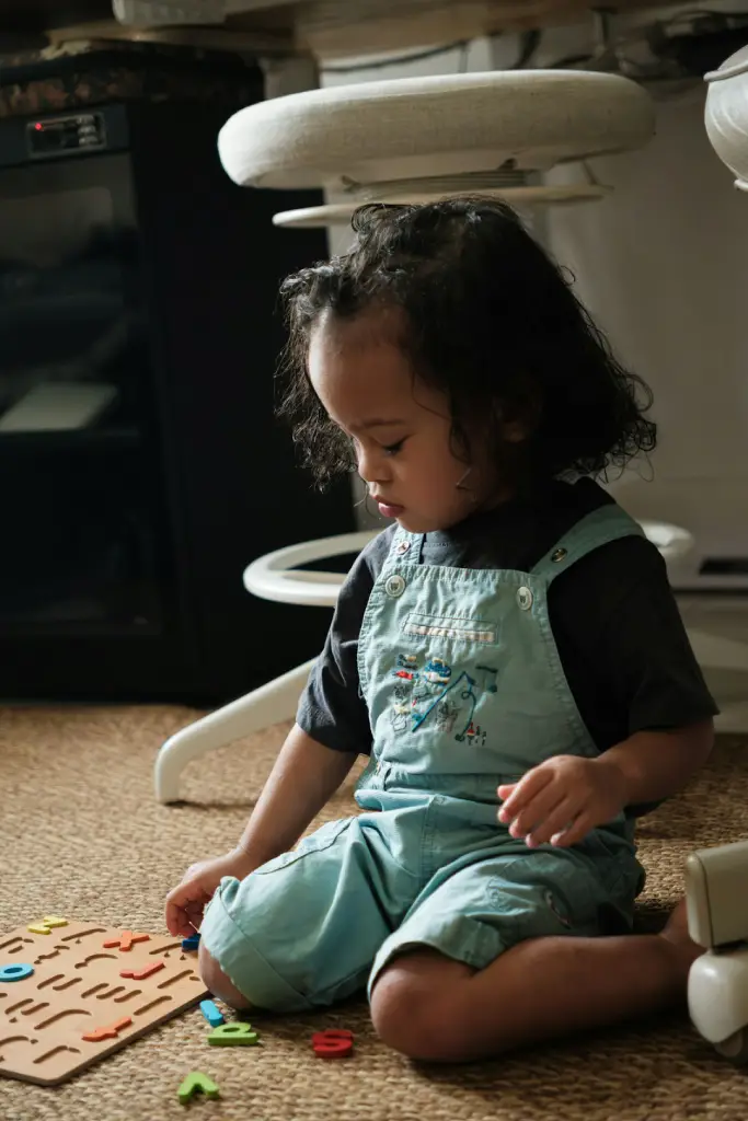child playing with alphabet letters