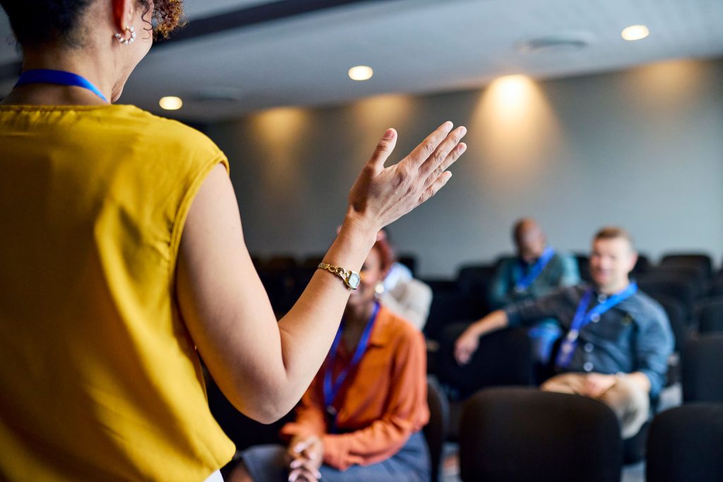 Facilitator speaking to a small group during an educational session